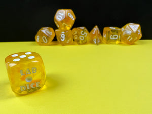 Borealis Luminary Canary polyhedral set, showing off brilliant sparkly yellow dice, showing off the d6.
