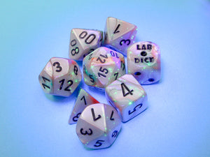 Lustrous Sea Shell polyhedral dice set glowing under a black light.