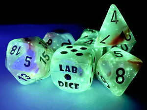 Lustrous Sea Shell dice glowing under a black light.