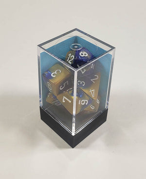 A close up of the Chessex Gemini blue and Gold polyhedral dice set in its package.