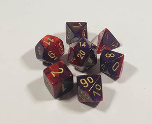 A close up of the Chessex Gemini Purple and Red polyhedral dice set.