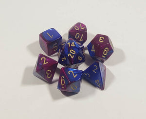 A close up of the Chessex Gemini Blue and Purple polyhedral dice set.