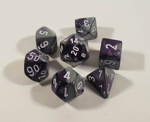 A close up of the Chessex Gemini Purple Steel polyhedral dice set.