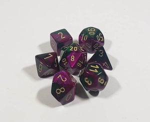 A close up of the Chessex Gemini Green and Purple polyhedral dice set.
