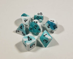A close up of the Chessex Gemini Teal and White polyhedral dice set.