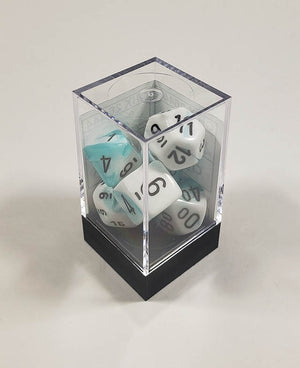 A close up of the Chessex Gemini Teal and White polyhedral dice set in its package.