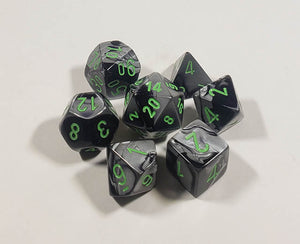 A close up of the Chessex Gemini Black and Grey polyhedral dice set.