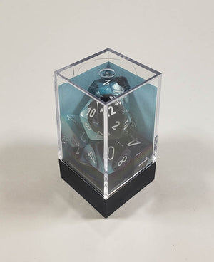 A close up of the Chessex Gemini Black and Shell polyhedral dice set in its package.