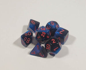 A close up of the Chessex Gemini Black and Starlight polyhedral dice set.