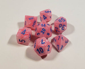 A close up of the Chessex Lustrous Pink polyhedral dice set in its package.