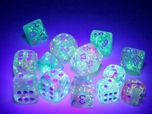 A close up of the Chessex Nebula Wisteria dice set under blacklight to highlight their luminescent features.