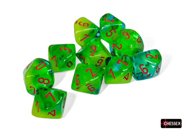 A set of multicolored dice featuring green and teal colors with orange numbering.