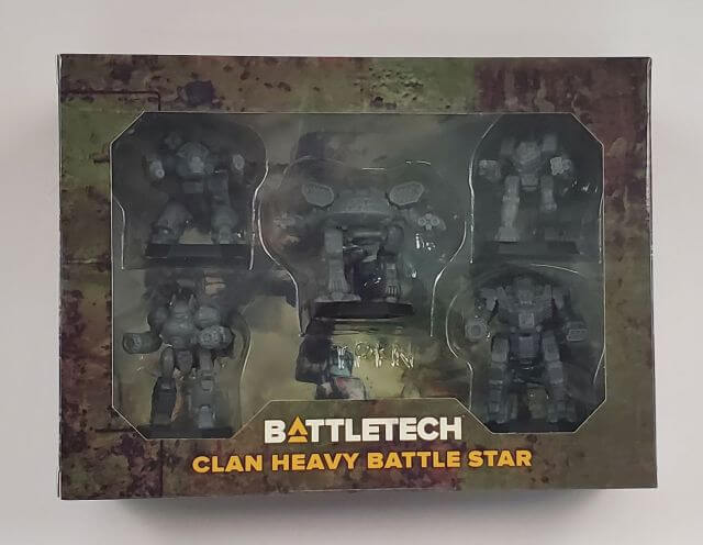 Packaging for BattleTech: Clan Heavy Battle Star game, showcasing five metal miniatures inside, with a camouflage-patterned box.