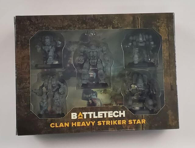 Boxed product of BattleTech: Clan Heavy Striker Star with five miniature models depicted in the OmniMechs style, including Gargoyle, Hellbringer, Mad Dog, Ice Ferret, and Viper.