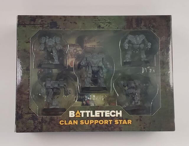 The image shows a product called BattleTech: Clan Support Star, which includes a set of model mechs and cards for the game. The mechs are displayed in a packaging that has a battle-damaged look, typical of the BattleTech series.