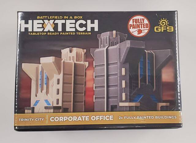Packaging for BattleTech Hextech Terrain featuring a 6mm scale model of a corporate office building, with the text 'Fully Painted' and 'Trinity City, Corporate Office' on the box.