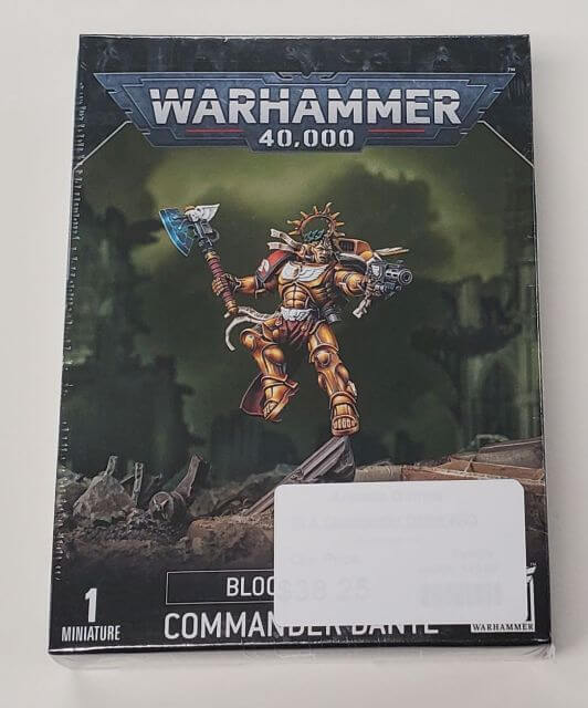 Packaging for Warhammer 40,000 Blood Angels Commander Dante miniature, featuring an illustration of the character in combat gear against a space-themed backdrop.