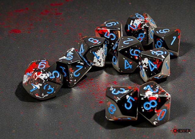 Set of black dice with blue and red numbers on a dark surface