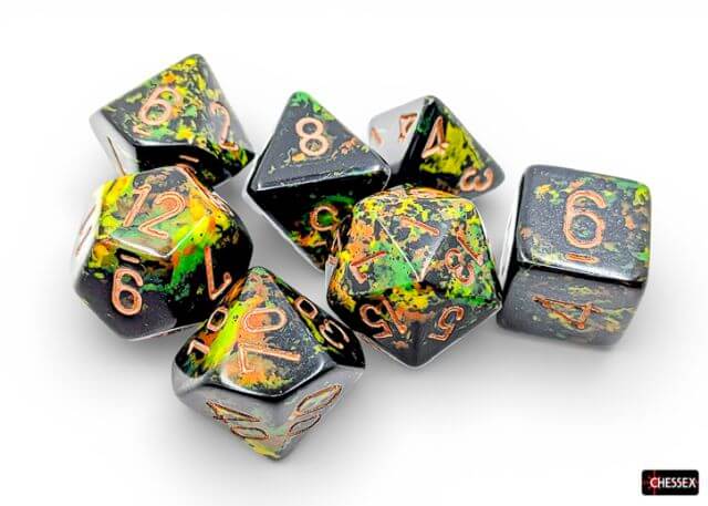 Set of Chessex dice with black, green, and orange speckled pattern on a white background