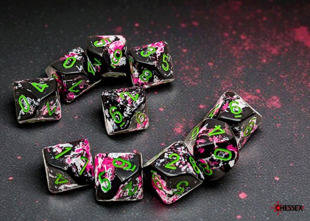 Set of dice with black, pink, and green design on a dark surface