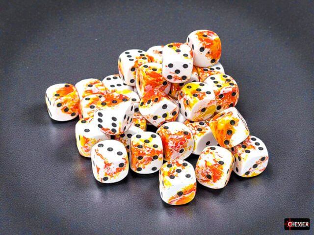 Set of dice with fish pattern on a dark surface, featuring the Chessex brand.