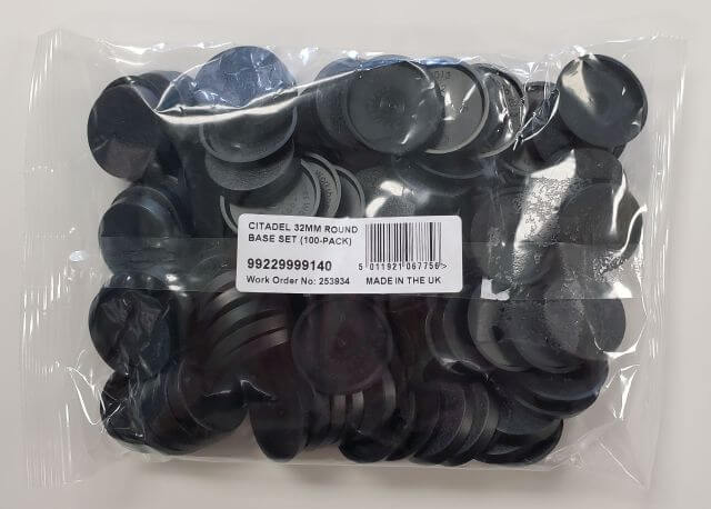 A pack of Citadel 32mm round bases for miniatures, still in plastic wrapping, predominantly black in color.