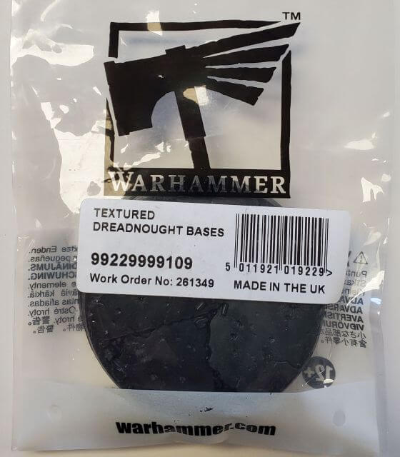 Packaged Citadel 60mm Round Textured Bases for model making, with the Warhammer logo visible on the packaging.