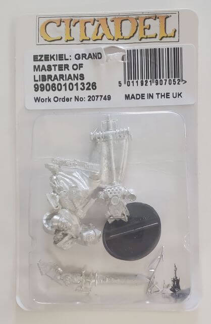 Citadel miniature blister pack featuring Ezekiel, Grand Master of Librarians, a metal figurine with a force weapon, backpack, and banner, packaged with a 25mm round base.