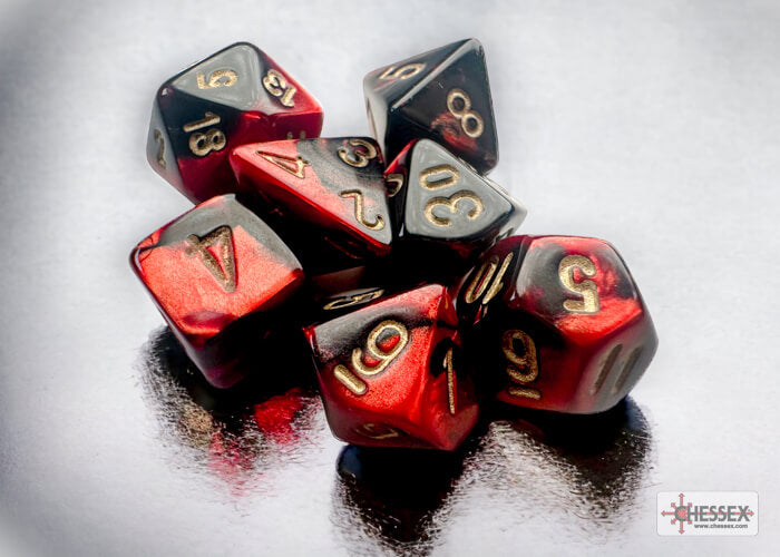 A close of the Chessex Gemini Black-Red with gold mini dice set.