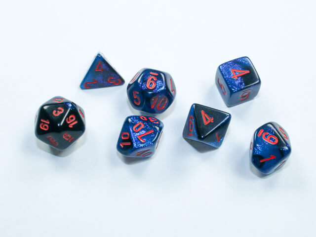 A close of the Chessex Gemini Black Starlight with Red mini dice set.