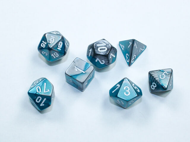 A close of the Chessex  Gemini Steel-Teal with white mini dice set.