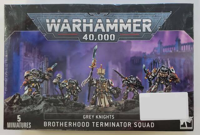 Boxed set of Warhammer 40,000 Grey Knights miniatures, featuring five characters equipped for battle, with no visible branding on the packaging.