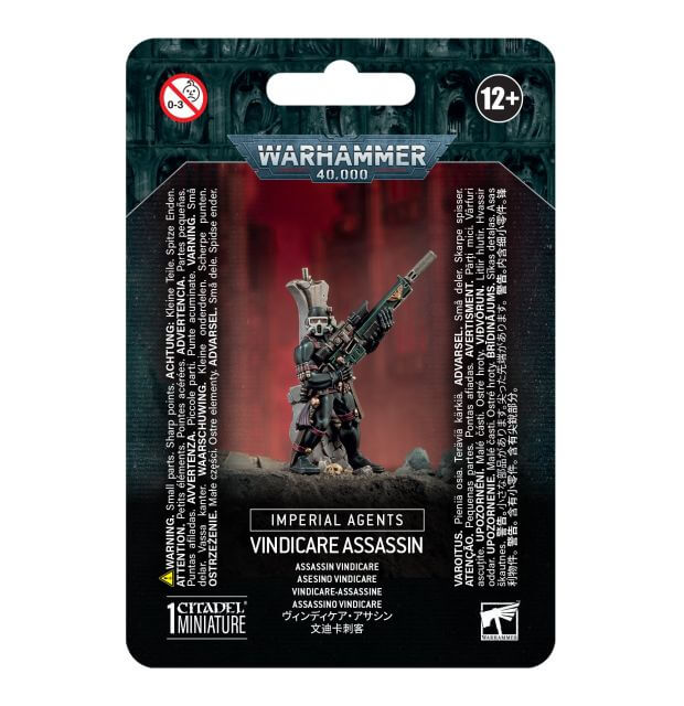 Packaging for Warhammer 40,000 Imperial Agents Vindicare Assassin miniature, featuring the assembled and painted figure, with red and black background on the card.