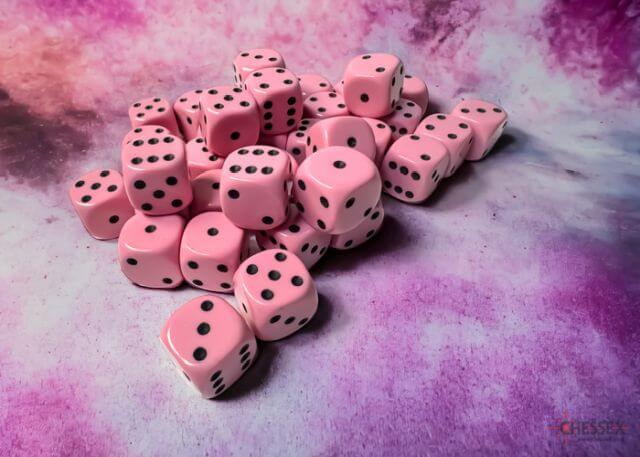 A close of the Chessex pastel pink with black 12mm d6 dice set.