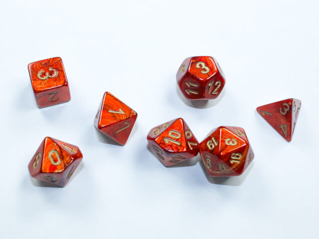 A close of the Chessex scarab scarlet with gold mini dice set.