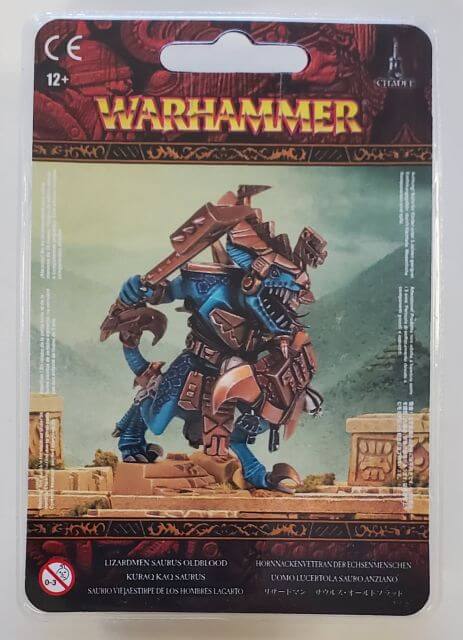 Packaging for Warhammer Seraphon Saurus Oldblood, featuring an illustration of the miniature on a card with a fantasy setting in the background.