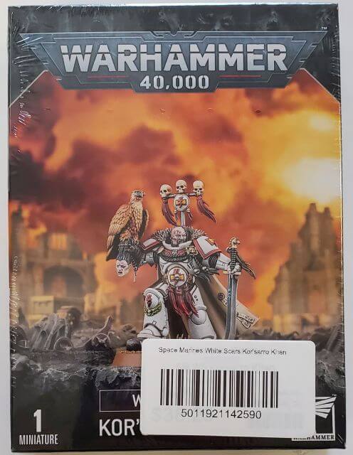 Packaging for a Warhammer 40,000 miniature, featuring Space Marines against a fiery battle backdrop.