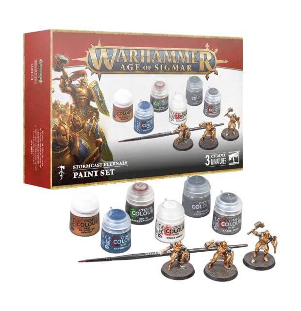 The image shows the Stormcast Eternals Paint Set which includes three plastic miniatures, a paintbrush, and six paint pots with different colors, all displayed on a box cover.