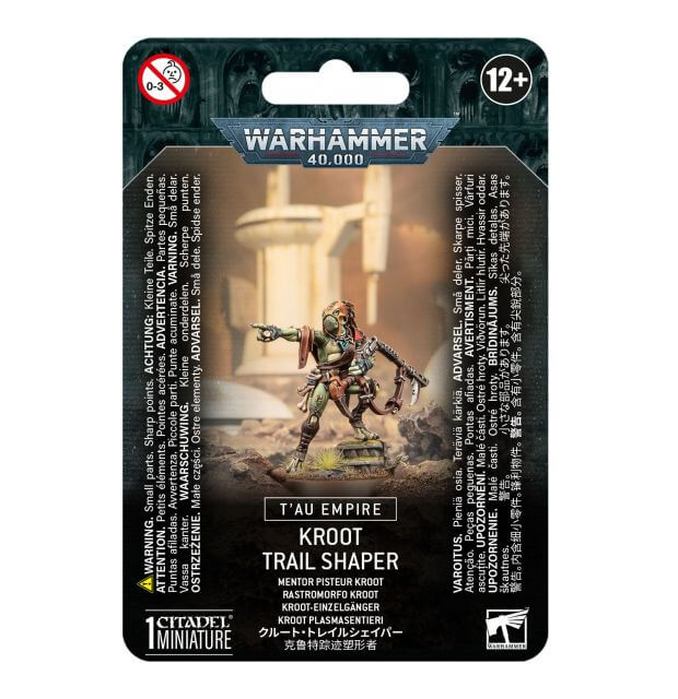 Packaging for Tau Empire Kroot Trail Shaper miniature, featuring an illustration of the character on a card with game-related text.
