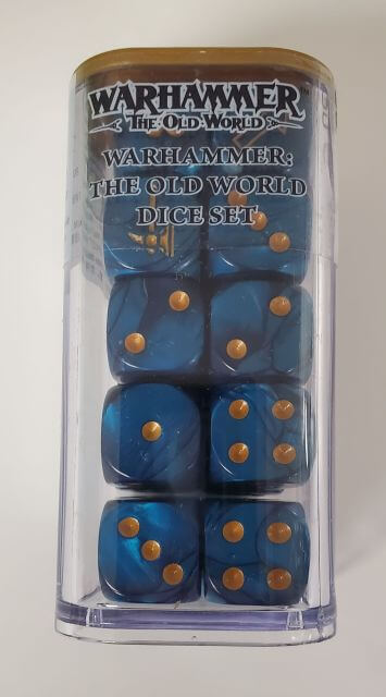 A set of blue dice with gold markings, including multiple D6 dice and an Artillery die, packaged in a clear container.