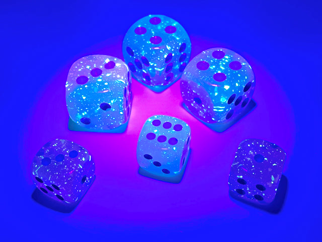 A close up of the Gemini Gel Green-Pink with blue 12mm d6 set under blacklight to highlight their luminescent quality.