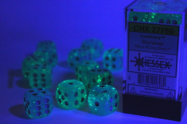 A close up of the Chessex Luminary Sky wth Silver 12mm  d6s under black light.