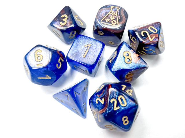 A set of polyhedral dice with blue and gold colors, including various shapes such as 4-sided, 6-sided, 8-sided, 10-sided, 12-sided, 20-sided, and a percentile dice.