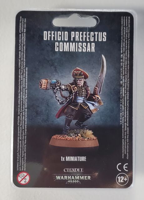 Packaging for Astra Militarum Officio Prefectus Commissar miniature, featuring the assembled and painted figure on the front.