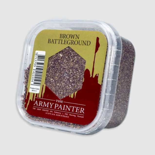 A clear plastic container with brown colored sand labeled 'Brown Battleground' by The Army Painter.