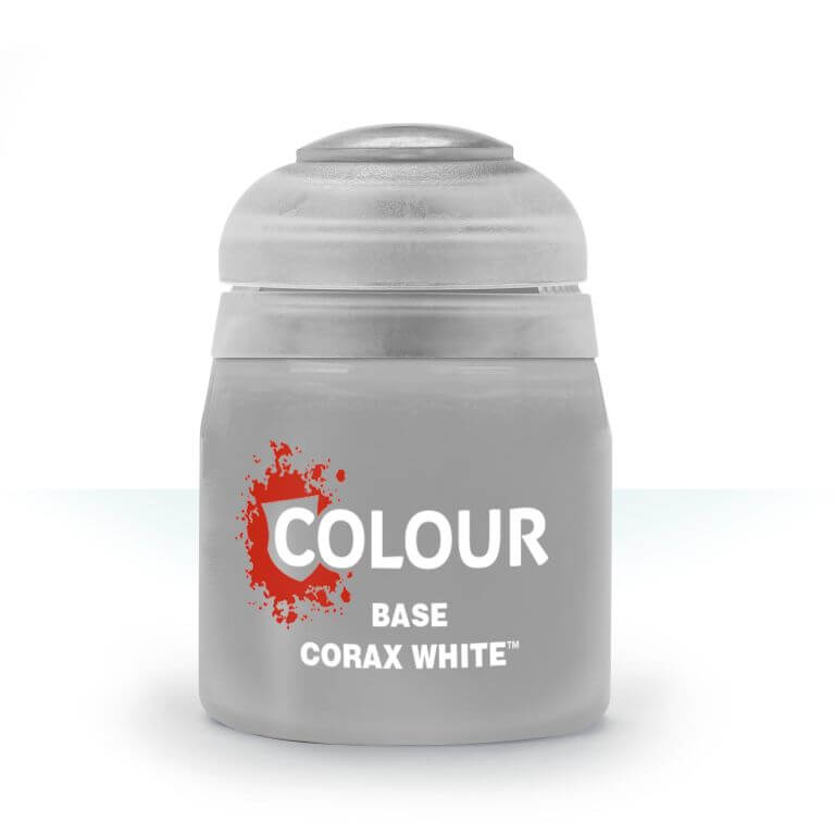 A pot of Citadel base paint in the color 'Corax White'. The pot is labeled with the brand and product name, and has a white lid with a small amount of paint splatter design.