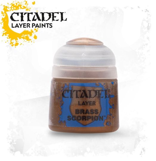A pot of Citadel Layer acrylic paint in the color 'Brass Scorpion'. The paint is designed for use on miniatures and is presented in a small, round, plastic container with a lid.