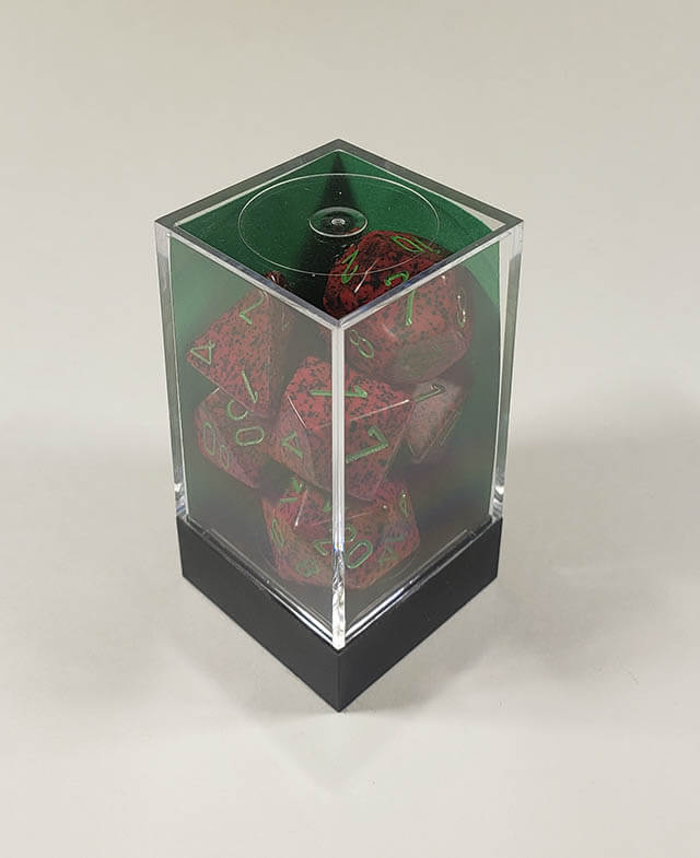 A close up of the Chessex specked strayberry polyhedral dice set in its package.