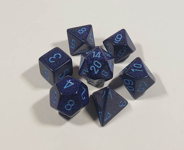 A close up of the Chessex specked Cobalt polyhedral dice set.
