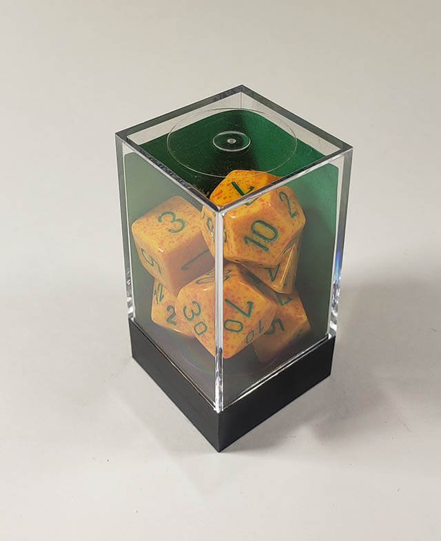 A close up of the Chessex specked Lotus polyhedral dice set in its package.